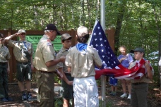 Scouts hoist up the new flag.